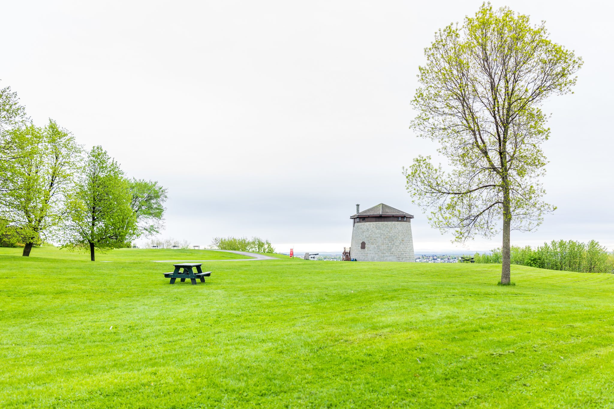 Quebec City, Canada - May 30, 2017: Martello tower watchtower in plaines d'Abraham with green grass field