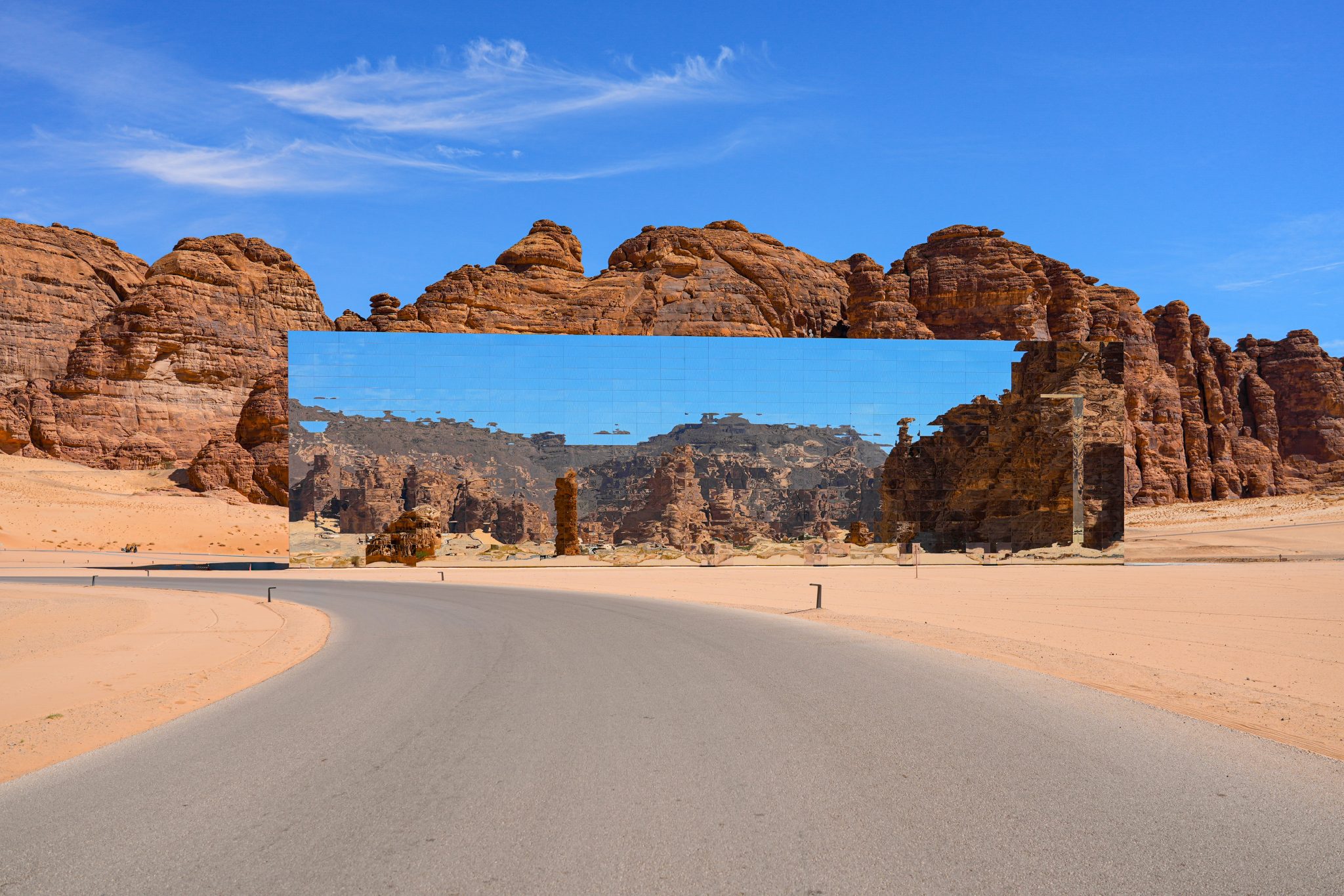 The Maraya mirrored concert hall reflecting the ancient desert mountains of Ashar Valley in AlUla, Saudi Arabia